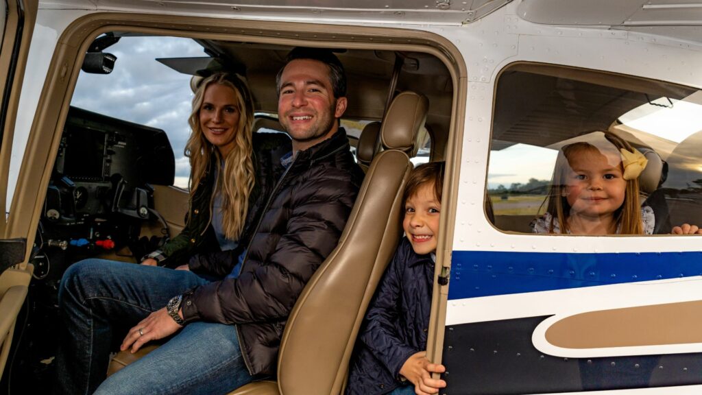 Family posing in a plane.