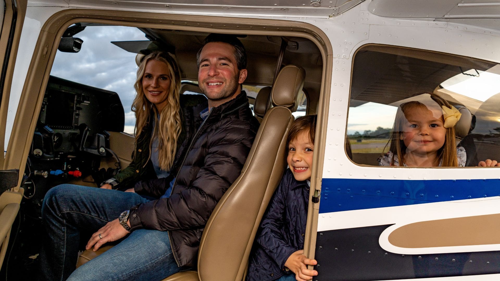 Family posing in a plane.