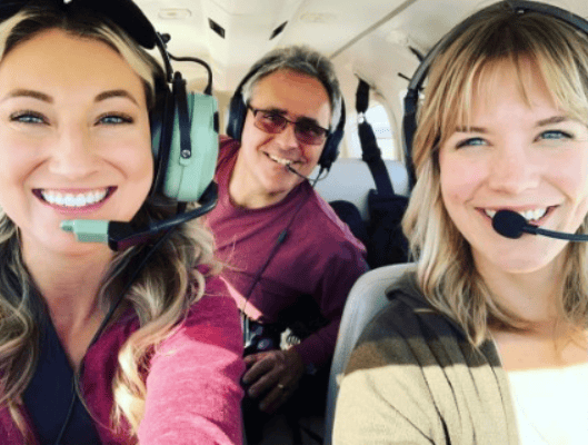 Group smiling in a plane.