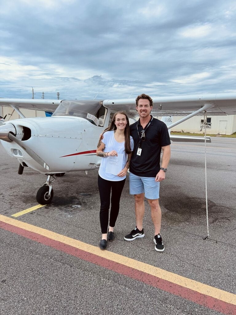 Two people outside of plane